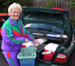Isabel, a meals on wheels driver, fills her car boot for meal deliveries